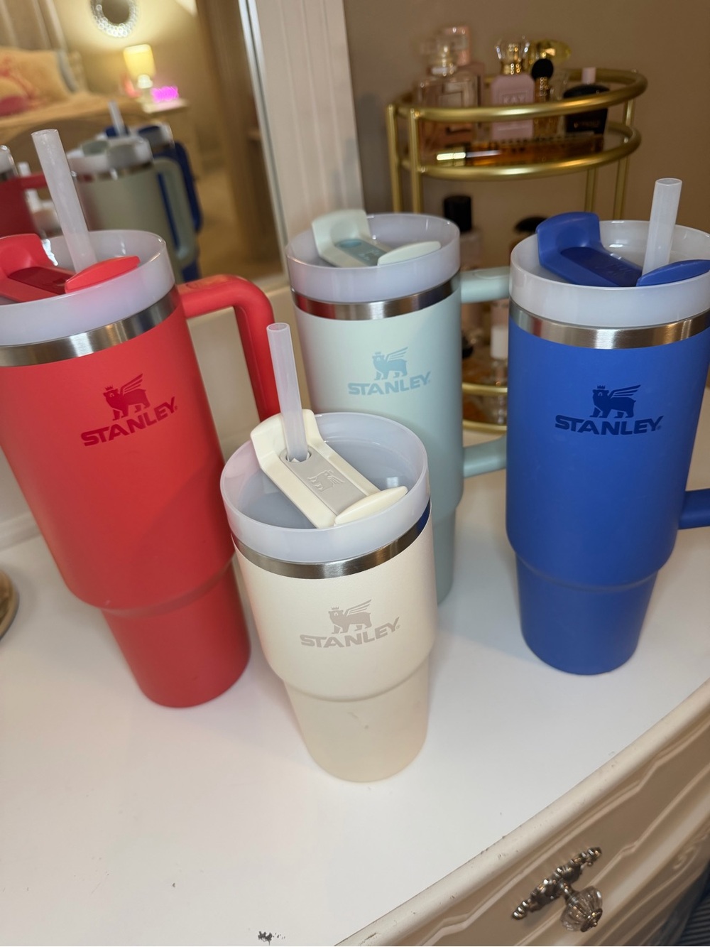 Stanley Travel Mugs in Blue, Red, Cream, and Light Green